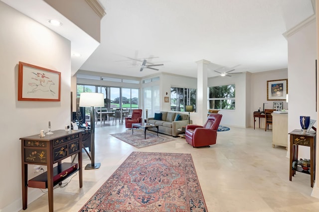 living room featuring ceiling fan, a healthy amount of sunlight, ornamental molding, and decorative columns