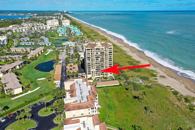 bird's eye view featuring a view of the beach and a water view