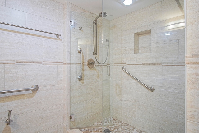 bathroom with a shower with shower door