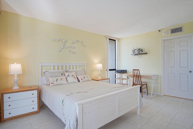 bedroom with visible vents and a textured ceiling