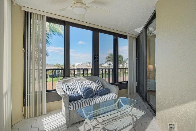 sunroom / solarium featuring ceiling fan