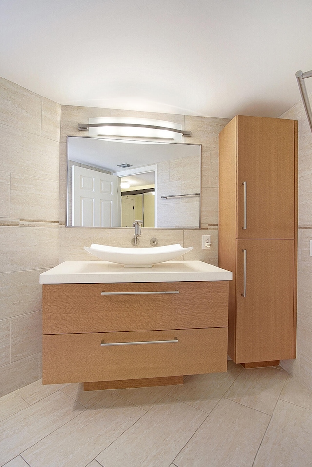 bathroom featuring tile walls and vanity