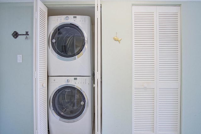 laundry room featuring stacked washing maching and dryer and laundry area