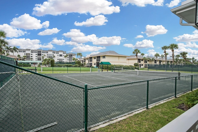 view of tennis court featuring fence