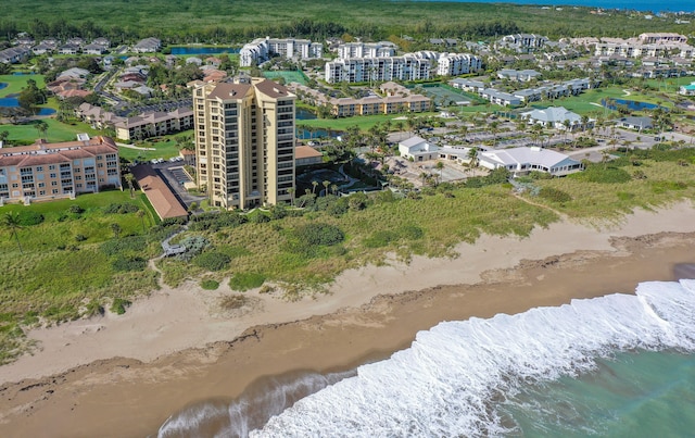 bird's eye view with a water view and a beach view