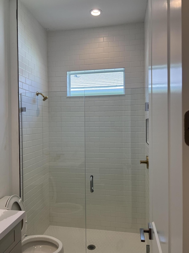 full bathroom with vanity, a shower stall, and toilet