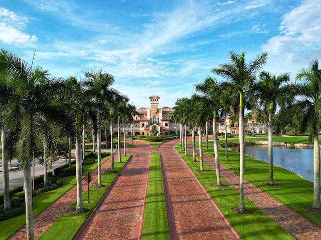 view of community featuring a water view and a lawn