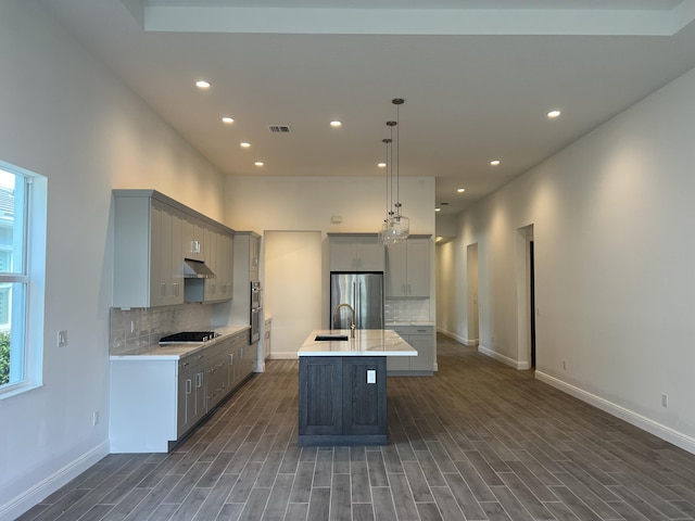 kitchen featuring visible vents, gray cabinetry, a sink, stainless steel appliances, and light countertops