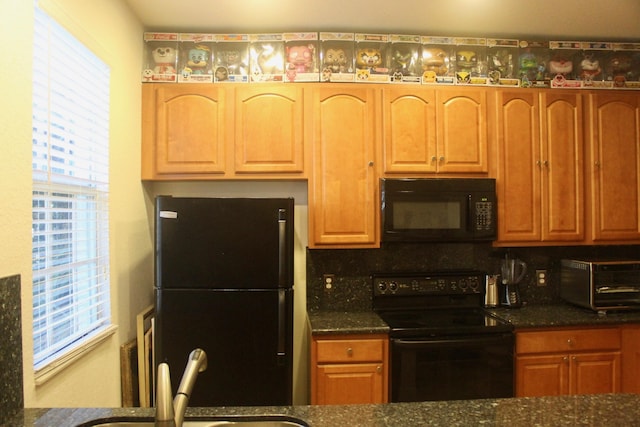 kitchen with dark stone countertops, decorative backsplash, sink, and black appliances