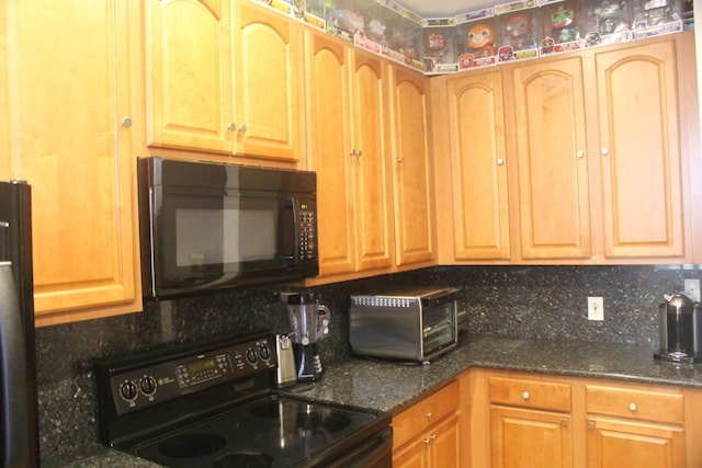 kitchen with decorative backsplash, dark stone countertops, and black appliances