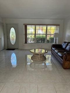 living room featuring tile patterned flooring and a wealth of natural light