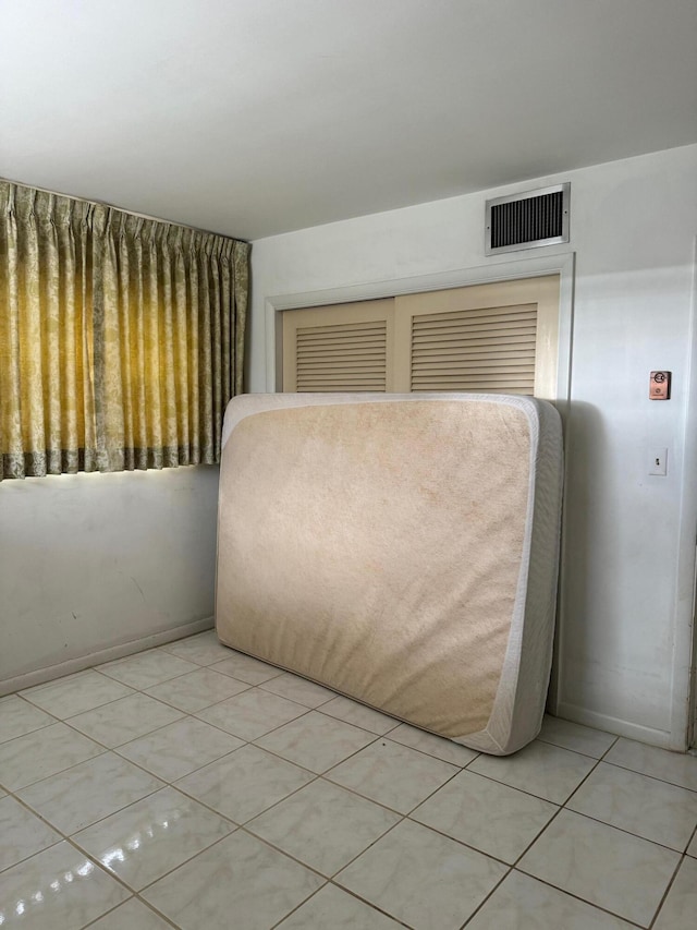 unfurnished bedroom featuring light tile patterned floors