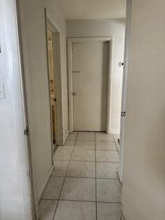 hallway with light tile patterned floors