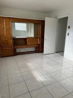 spare room with light tile patterned floors