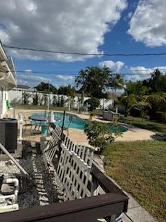 view of pool featuring central AC unit and a patio area