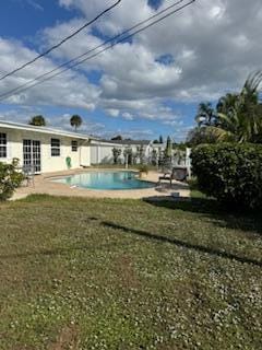 view of swimming pool with a yard and a patio