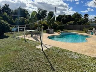 view of swimming pool featuring a patio area and a lawn