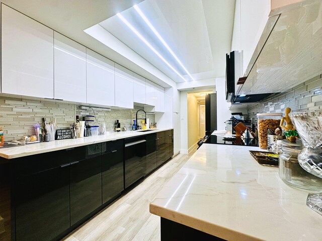 dining space with sink and light wood-type flooring