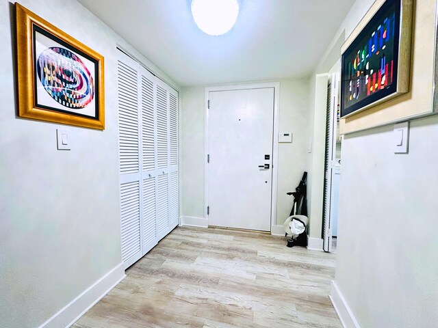 hallway with light hardwood / wood-style flooring