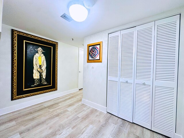 hallway with light hardwood / wood-style flooring