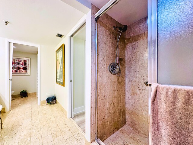 bathroom featuring a shower with shower door