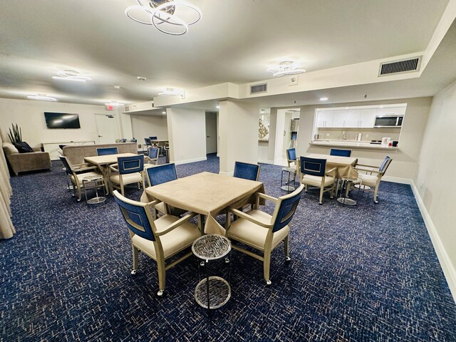 dining area with dark carpet