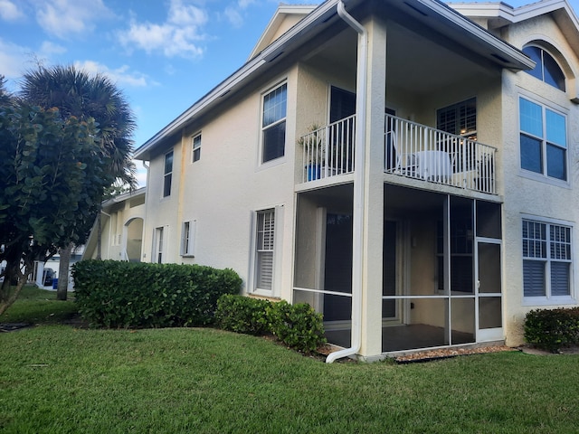 view of side of property with a lawn