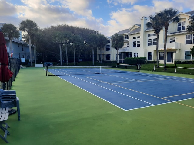 view of tennis court with basketball hoop