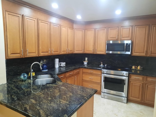 kitchen with dark stone counters, backsplash, sink, and stainless steel appliances