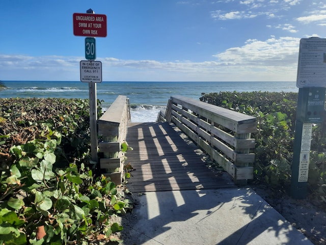 view of community with a water view and a view of the beach