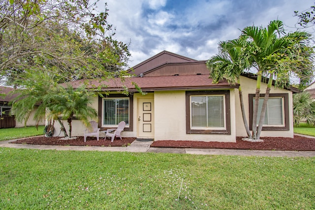 ranch-style house with a front lawn