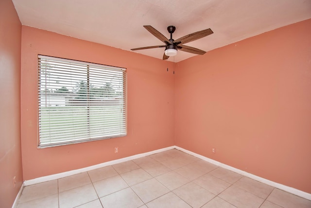 tiled spare room with ceiling fan