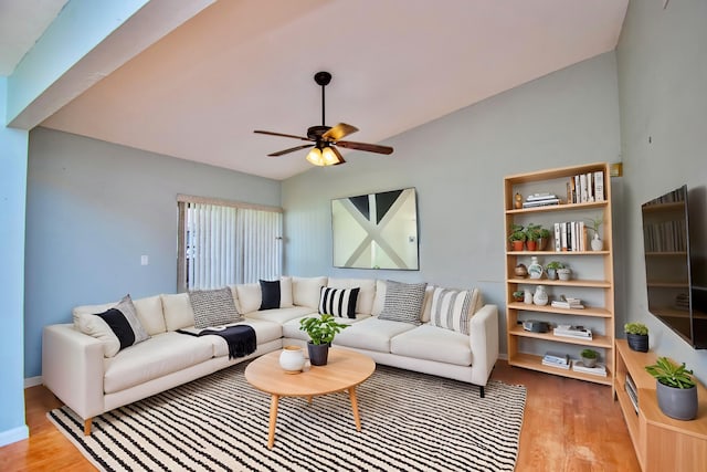 living room with vaulted ceiling, light hardwood / wood-style flooring, and ceiling fan