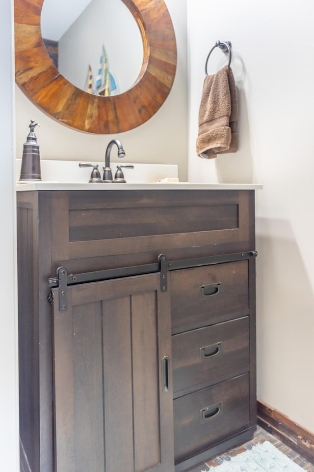 bathroom with vanity and wood-type flooring