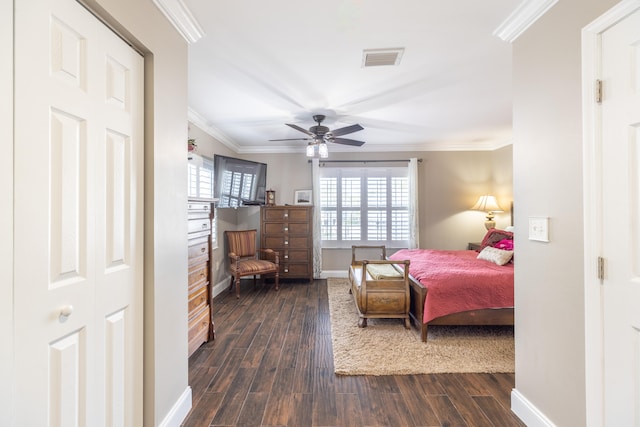 bedroom featuring ceiling fan, ornamental molding, and dark wood-type flooring