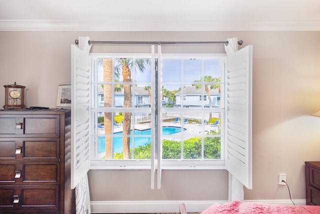 bedroom featuring crown molding and multiple windows