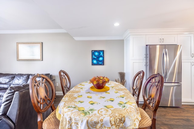 dining space with ornamental molding and dark wood-type flooring