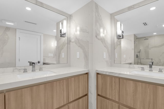 bathroom with vanity, tile walls, and walk in shower