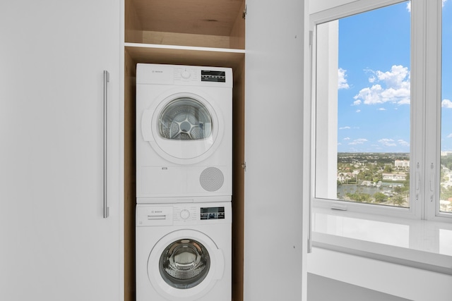 clothes washing area with stacked washer and dryer