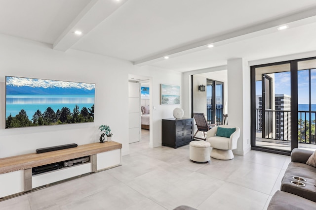 living room with beam ceiling, a water view, a healthy amount of sunlight, and french doors