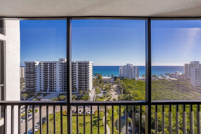 unfurnished sunroom featuring a water view