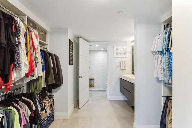 walk in closet featuring light tile patterned flooring