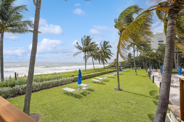 view of home's community with a lawn and a water view