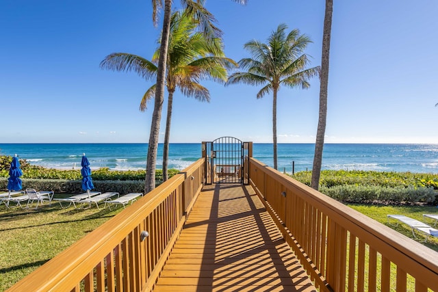 view of property's community featuring a water view and a beach view