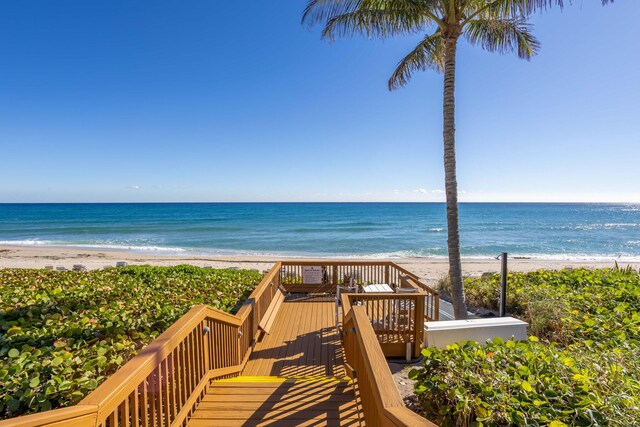 surrounding community featuring a water view and a lawn