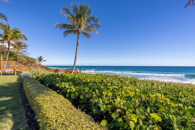 view of yard with a view of the beach and a deck with water view