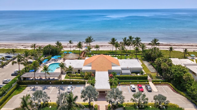 drone / aerial view with a water view and a view of the beach