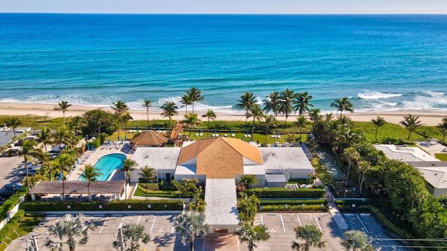 drone / aerial view featuring a water view and a view of the beach