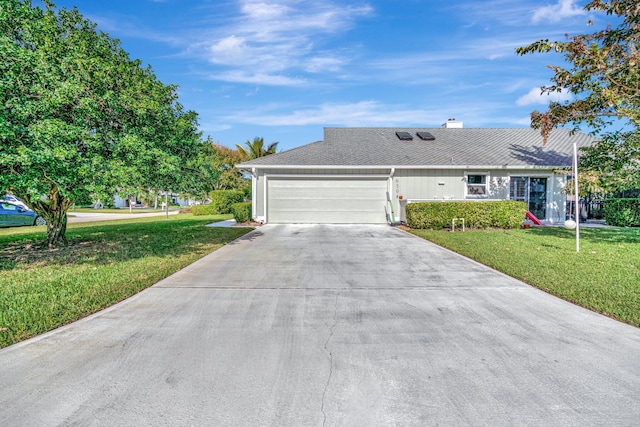 ranch-style house featuring a front yard and a garage