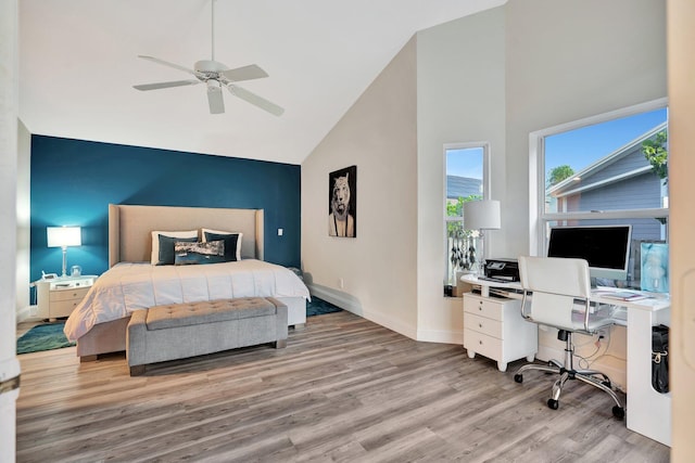 bedroom featuring high vaulted ceiling, light hardwood / wood-style flooring, and ceiling fan